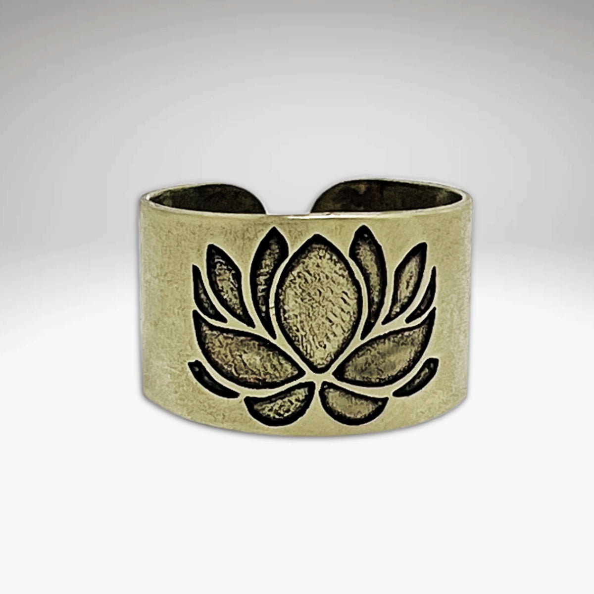 Lotus Adjustable Ring featuring an etched lotus design in antique brass finish, showcasing elegant beauty and adjustable fit.
