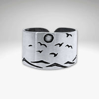 Flyover Adjustable Ring with Mountains, Waves, Full Moon and Birds displayed in matte silver design.