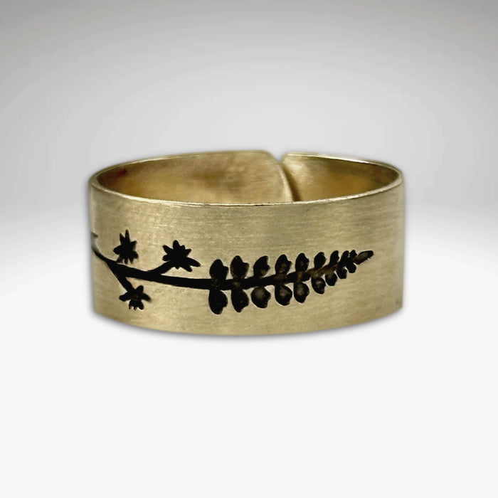 Lupine Adjustable Ring in Antique Brass featuring a wildflower design, adjustable for sizes 7 to 11.