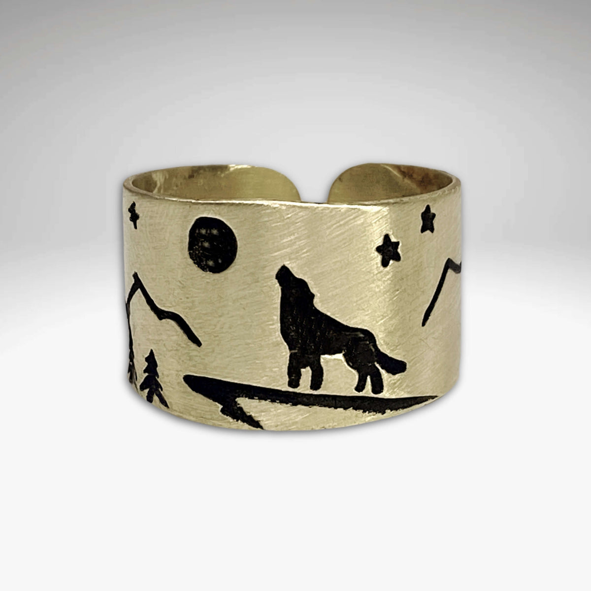 Midnight Wolf Adjustable Ring featuring a wolf design with mountains and stars on a brass finish.