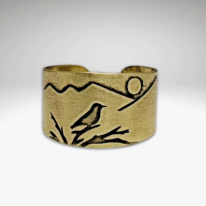 Mtn Bluebird Adjustable Ring features a hand-etched bluebird and mountainscape in antique brass finish.