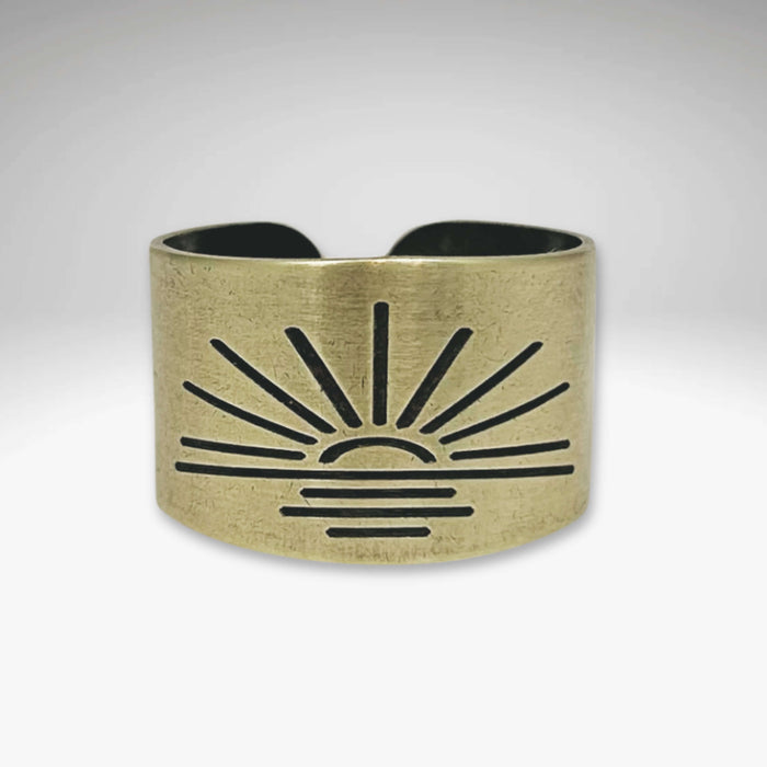 Antique brass Sunrise Adjustable Ring featuring a sunburst design, handmade in Montana, 0.5" wide, nickel-free.