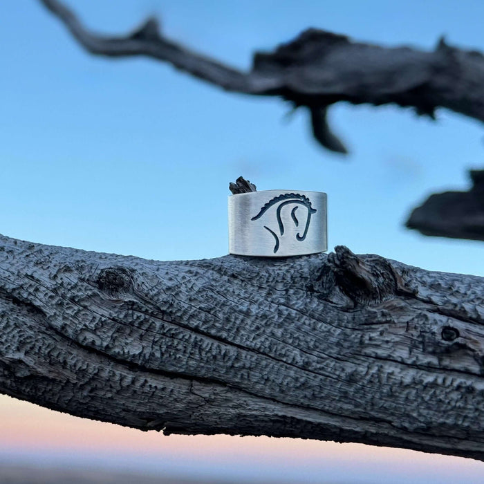White Horse Adjustable Ring on a natural wooden surface showcasing a dressage horse silhouette.