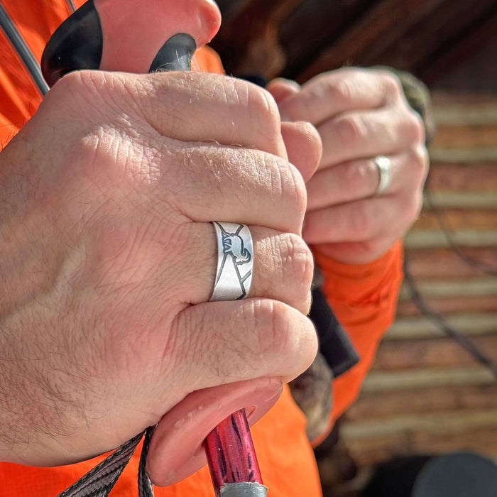 Close-up of hands wearing the Mountain Goat Adjustable Ring, showcasing its nature-inspired design.