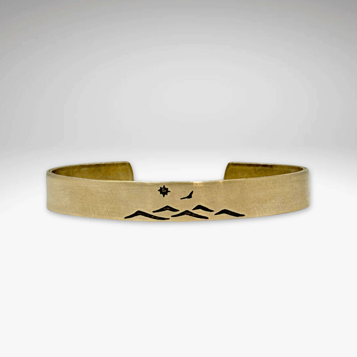 Fly Over cuff bracelet featuring a mountain design, bird, and sun, perfect for men and women, adjustable for comfort.