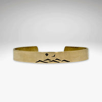 Fly Over cuff bracelet featuring a mountain design, bird, and sun, perfect for men and women, adjustable for comfort.