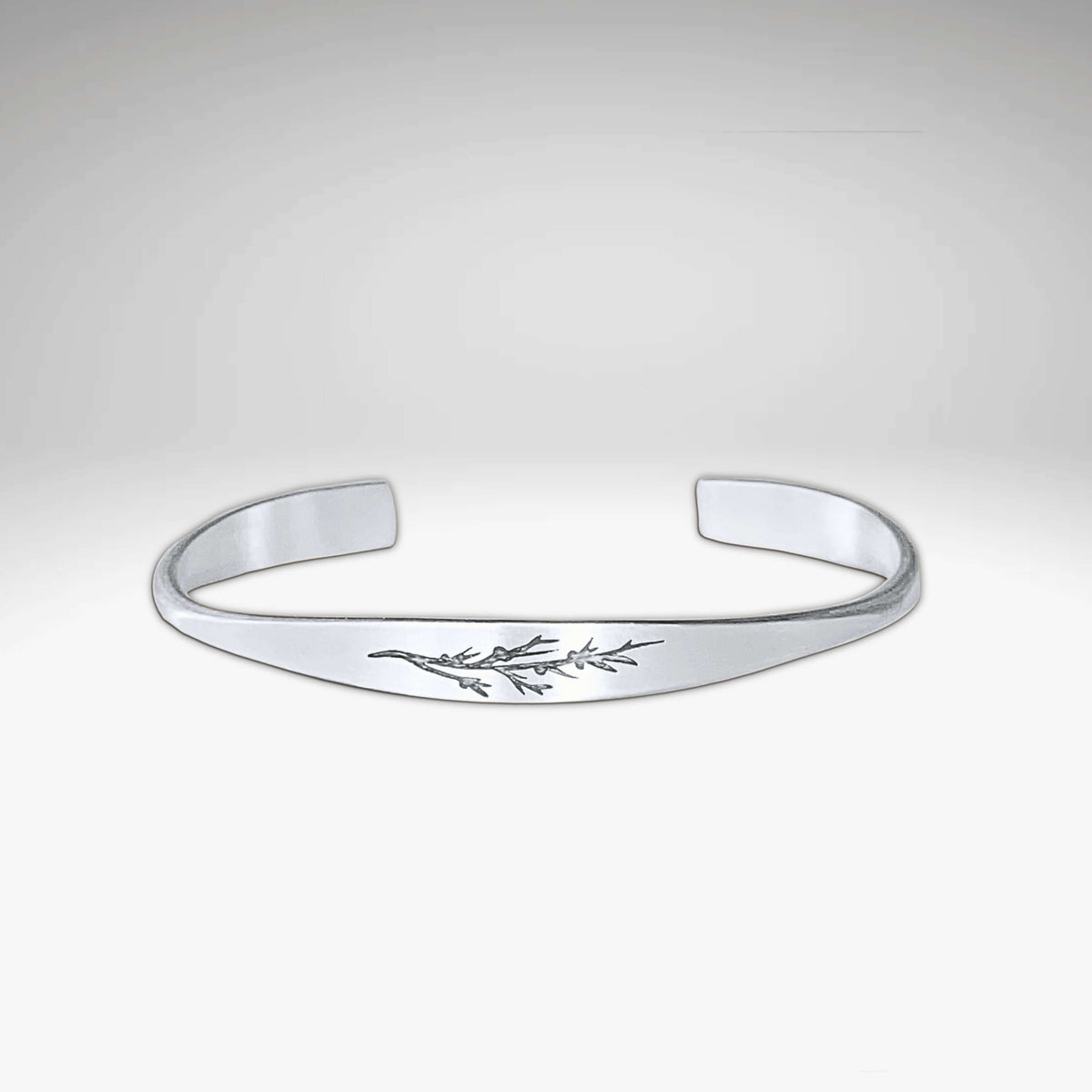 Juniper Signet Cuff Bracelet in matte silver finish featuring an etched juniper twig design.