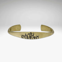 Wildflowers Signet Cuff featuring delicate wildflower engravings on a gold cuff bracelet.