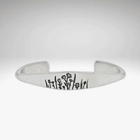 Wildflowers Signet Cuff featuring engraved wildflower design on a sleek silver cuff bracelet.