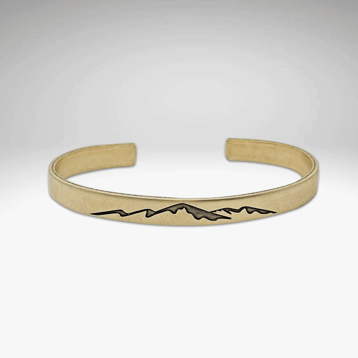 Mountainscape Mountain Cuff Bracelet in raw brass featuring etched mountain design, adjustable fit for men and women.