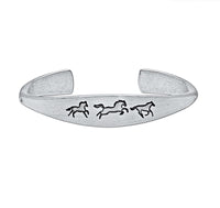 Wild Horses cuff bracelet in matte silver with three galloping horse designs, a timeless and elegant accessory.