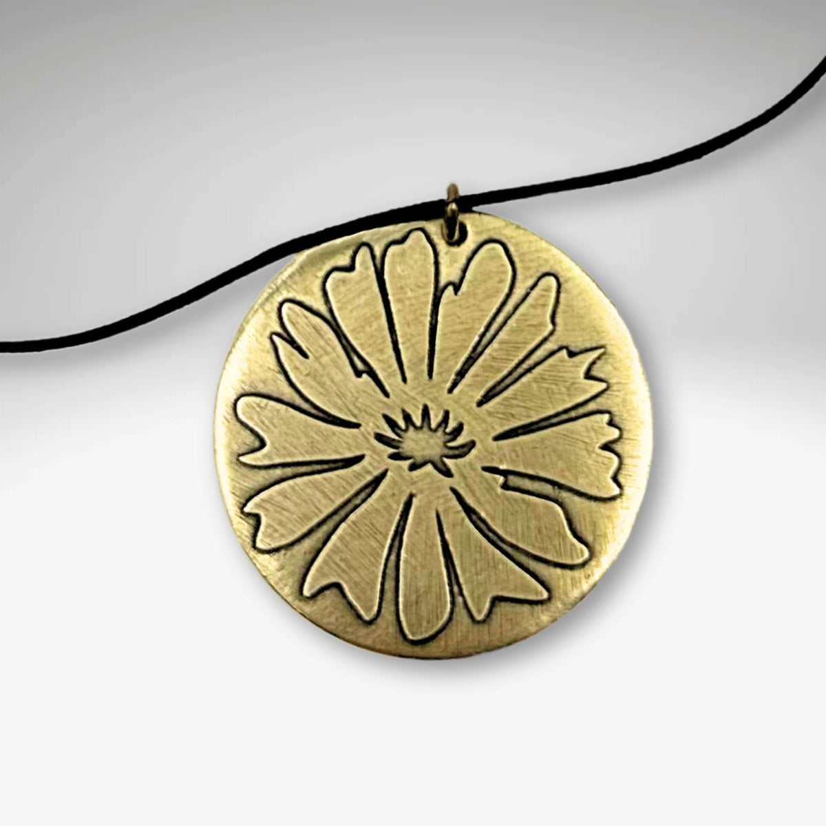 Closeup on our Brass Bitterroot Necklace on cord