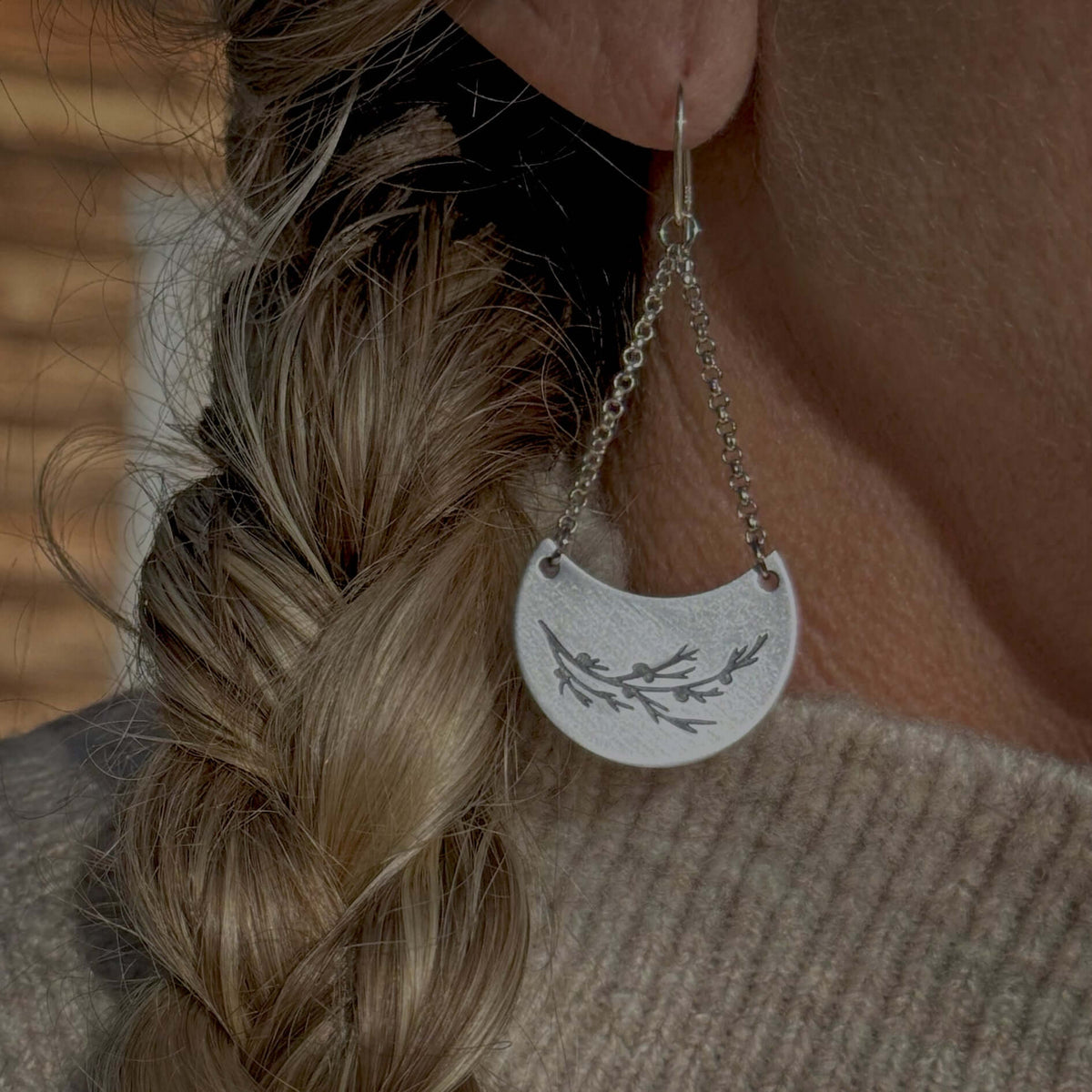 Juniper Earrings -Flowery Branch Nature dangle earrings showcasing a silver juniper design on a stylish earring.