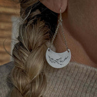 Juniper Earrings -Flowery Branch Nature dangle earrings showcasing a silver juniper design on a stylish earring.