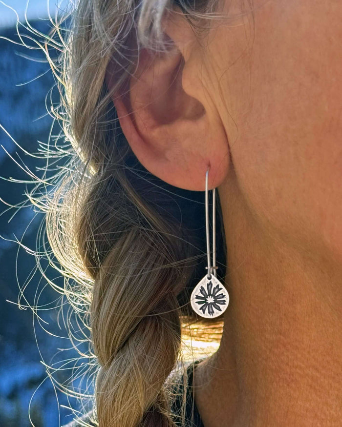 Bitterroot Drop Earrings featuring unique kidney earwire, showcased elegantly worn by a person with a braided hairstyle.