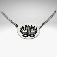 Simple Lotus Necklace on a silver chain featuring an intricately etched lotus pendant.