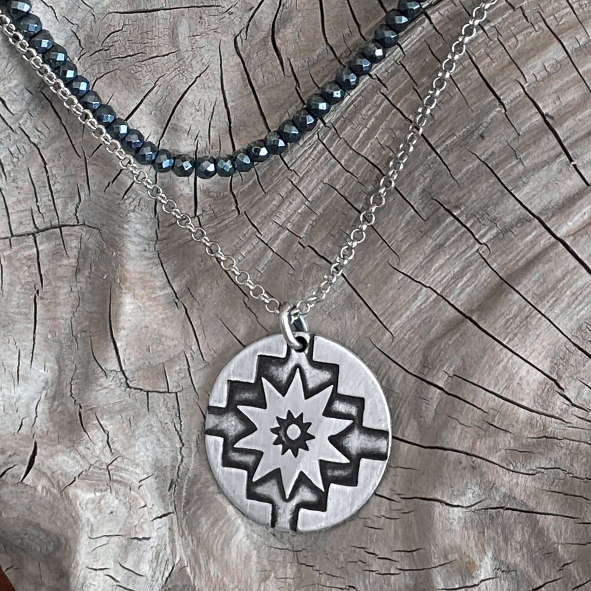 Northstar Necklace featuring a matte silver pendant on a textured background, symbolizing guidance and optimism.