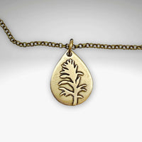 Teardrop pendant necklace featuring a silhouette of the Indian Paintbrush flower on a delicate chain.