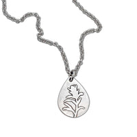 Teardrop pendant necklace featuring the silhouette of the Indian Paintbrush flower, symbolizing beauty and resilience.