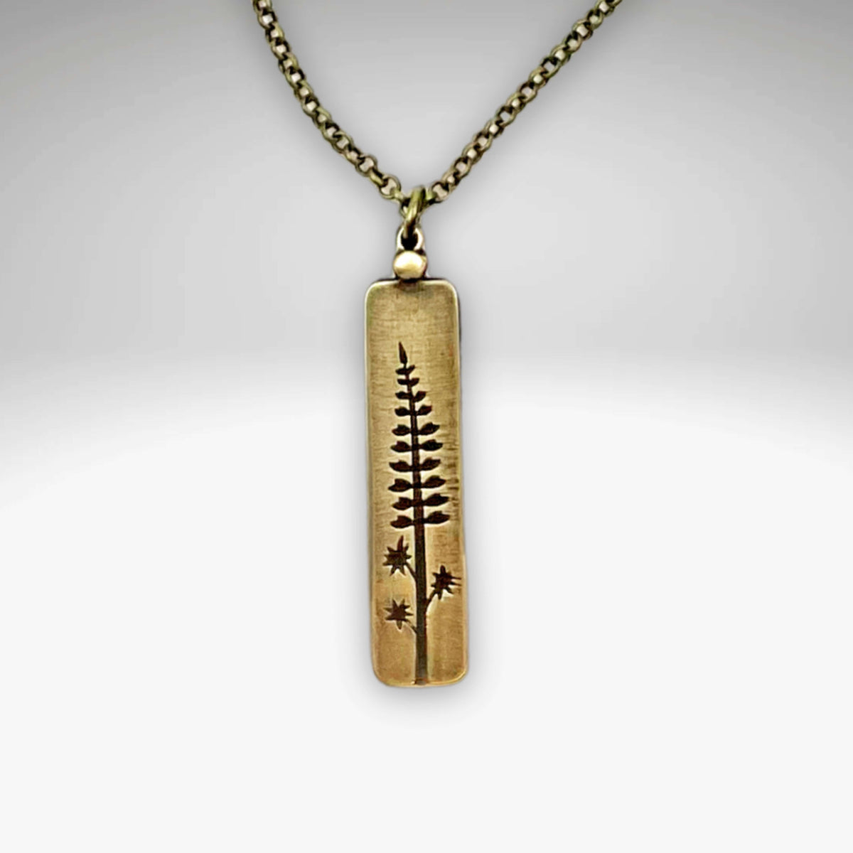 Lupine Necklace featuring a wildflower design, adjustable rolo chain for versatile summer accessory styling.