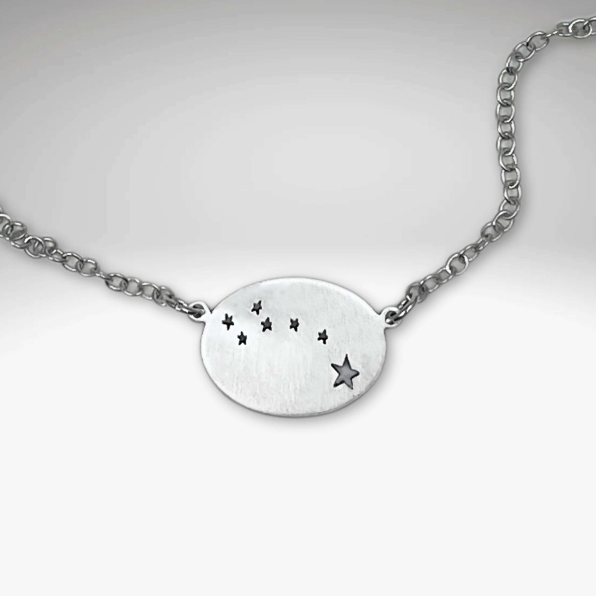 Matte Silver Little Dipper Necklace featuring seven stars from the Ursa Minor constellation on a delicate chain.