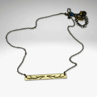 Antler Bar Necklace featuring a sleek design with a unique etching, adjustable chain and available in Matte Silver or Antique finishes.