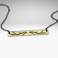 Antler Bar Necklace in Matte Silver with intricate etching highlighting nature's beauty.