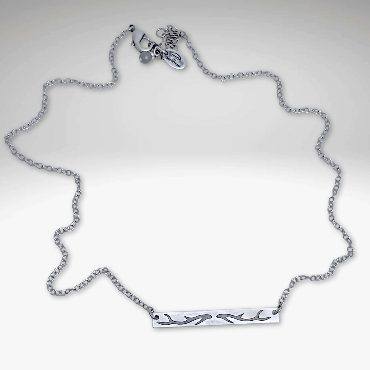 Antler Bar Necklace in Matte Silver with adjustable cable chain for showcasing nature's beauty.