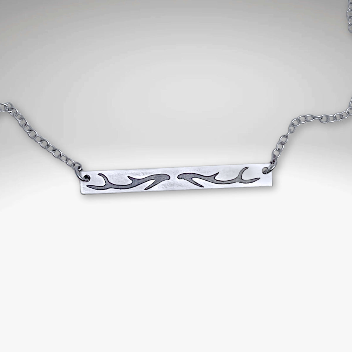 Sleek Antler Bar Necklace crafted with an acid-free etching process, adjustable 16" to 18" chain.