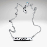 Bear Family Necklace in Matte Silver featuring a mama bear and cubs against a mountain backdrop.