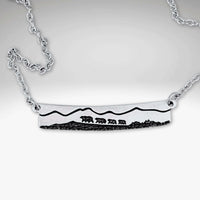 Bear Family Necklace in Matte Silver featuring a mama bear and three cubs with mountain scenery.