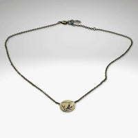 Mountain Bluebird Necklace featuring an oval pendant with intricate bluebird and mountain design, adjustable 16-18'' chain.