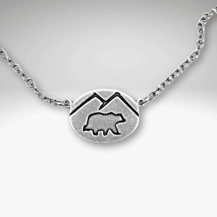 Mountain Bear Necklace in matte silver with mountain silhouette, featuring a 0.5" x 0.7" pendant and adjustable chain.