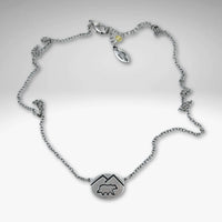 Mountain Bear Necklace in matte silver finish with a bear pendant and adjustable chain length.