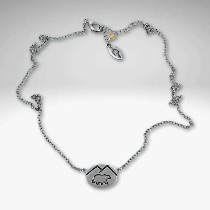 Mountain Bear Necklace in matte silver finish with a bear pendant and adjustable chain length.