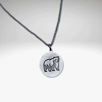 Grizzly bear pendant in matte silver featuring a grizzly bear design on a rolo chain, handmade in Montana.