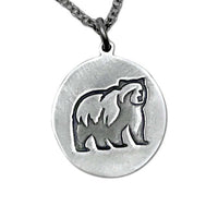 Grizzly bear pendant in matte silver featuring a grizzly bear design on a rolo chain, handmade in Montana.