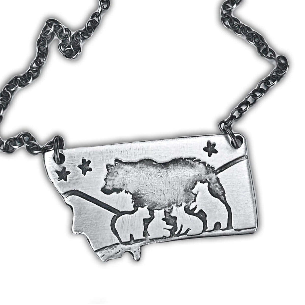 Montana outline pendant with a mama bear and four cubs in matte silver finish on a cable chain.