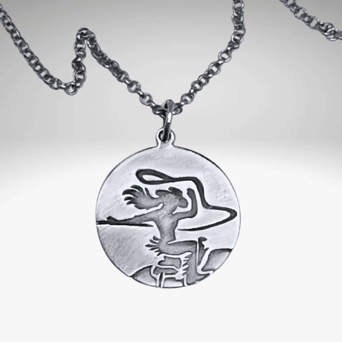 Silver pendant with a cowgirl on a horse with a lasso in matte silver on simple chain