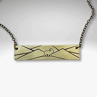 Antique Brass Mountain Goat Necklace design with mountain engraving on an adjustable chain.