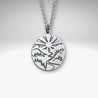 Going to the Sun Necklace pendant in silver, featuring a mountain landscape design, inspired by Glacier National Park.