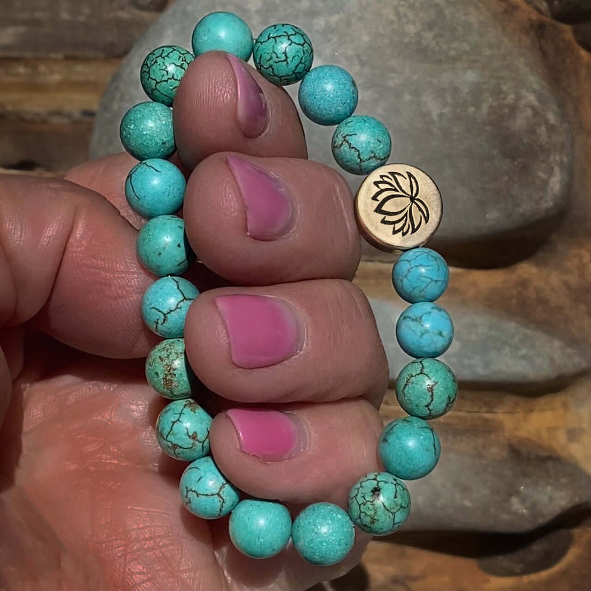 Lotus Stretch Bracelet - Gemstone Beaded Stretchy Bracelet with turquoise beads held in hand