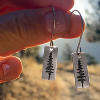 P Pine Tree Earrings featuring contemporary design with Ponderosa Pine Tree engraving, available in Matte Silver and Antique Brass finishes.