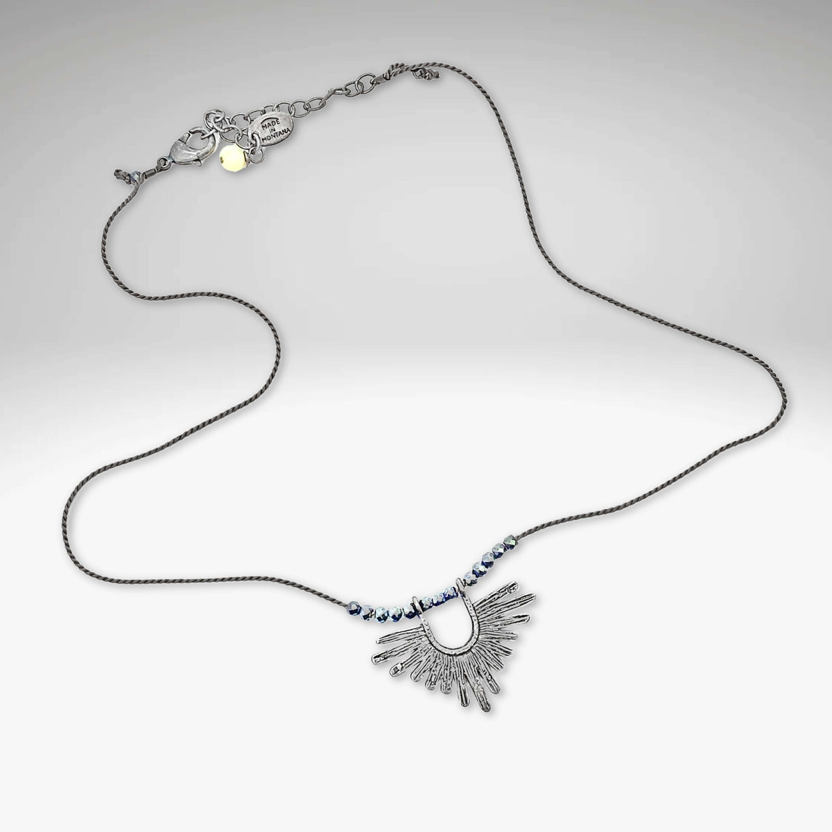 Sunbeam Necklace featuring geometric design, hematite beads, and adjustable silk cord from 16" to 18".