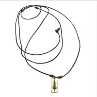 Pine Tree Necklace featuring a Ponderosa Pine pendant on a cord with beads and adjustable length, available in Antique Brass finish.