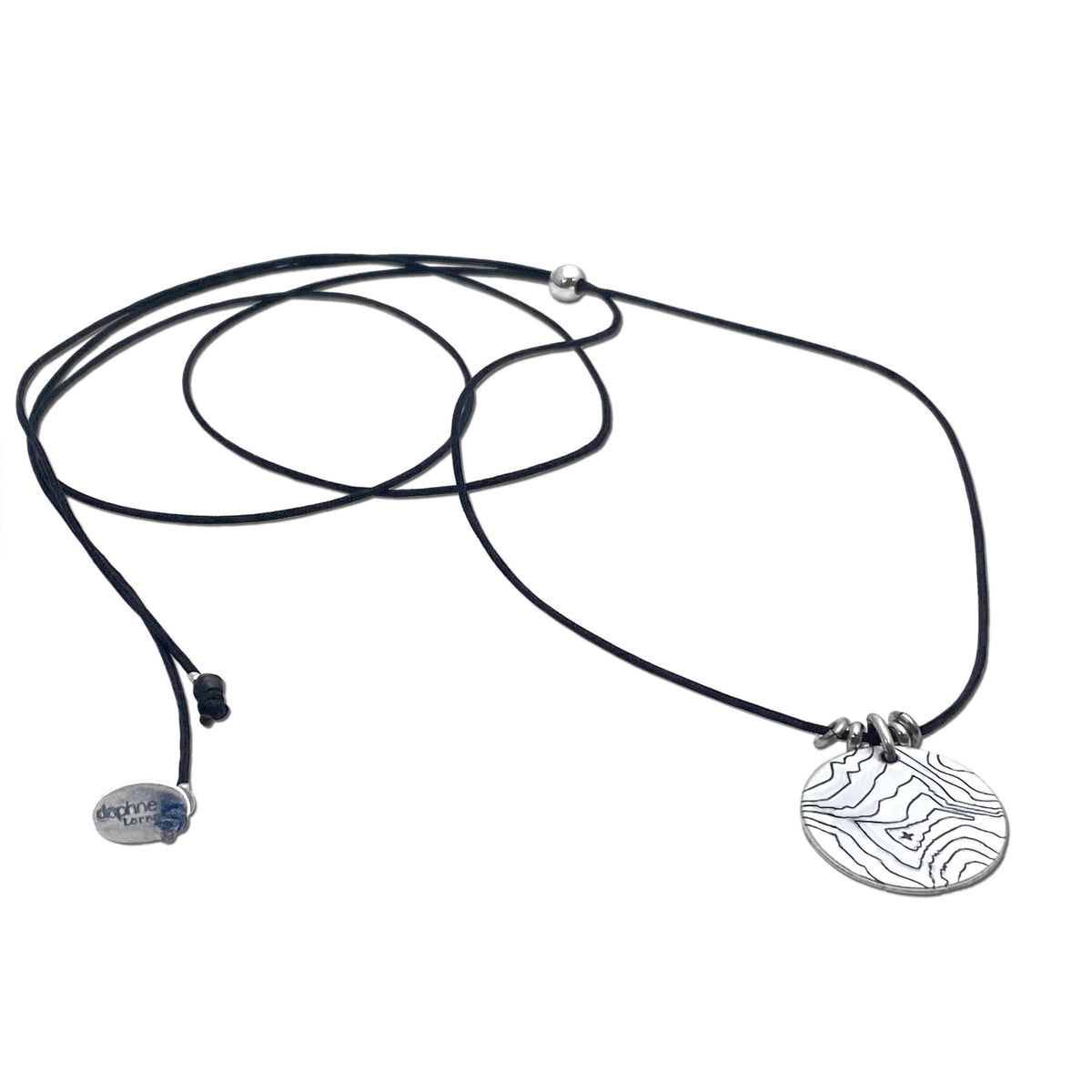 Rising Wolf Necklace featuring a detailed topographic map design on a pendant with a black cord.