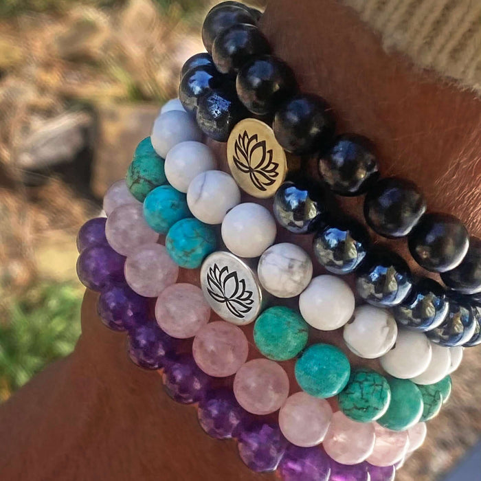 Lotus Stretch Bracelet - Gemstone Beaded Stretchy Bracelet stacked on wrist outdoors with natural light.