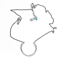 Horseshoe Necklace on a delicate rolo chain featuring a subtly hammered semi-circle pendant.