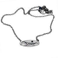 Glacier View Necklace featuring a mountain design on a matte silver pendant, adjustable 16"-18" cable chain.