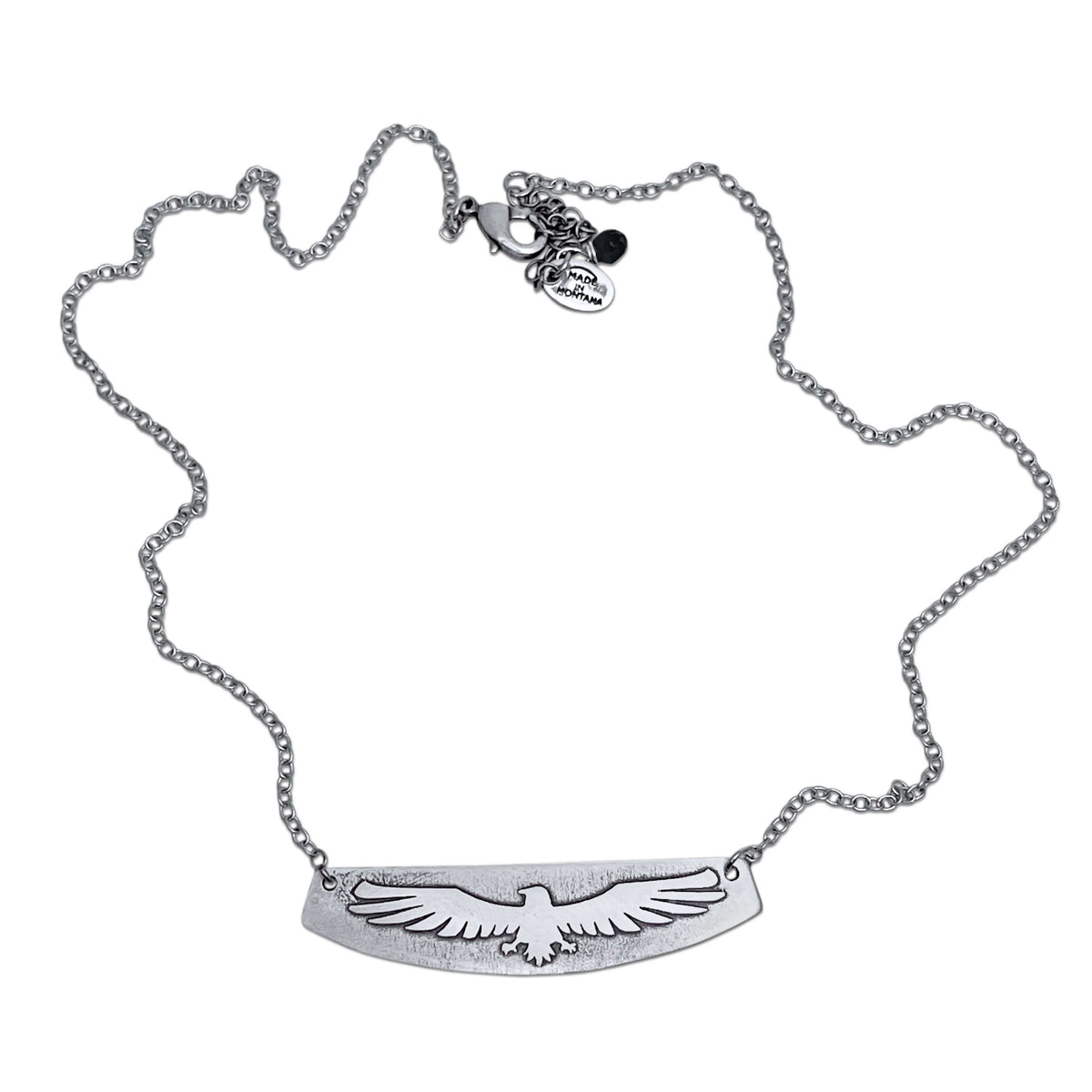 Freebird Necklace featuring a solid brass pendant etched with an eagle design on an adjustable cable chain.